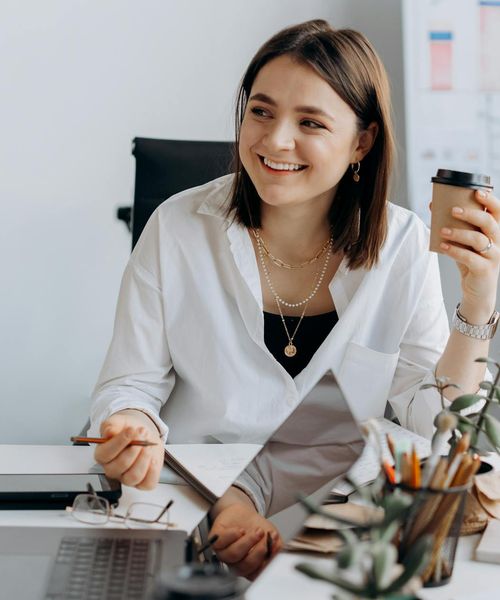 Person working at a modern office desk taking a short break for stretching.